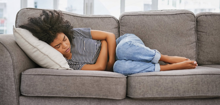 girl sick sleeping on couch