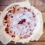 Clafoutis cherry pie on a rustic wooden background