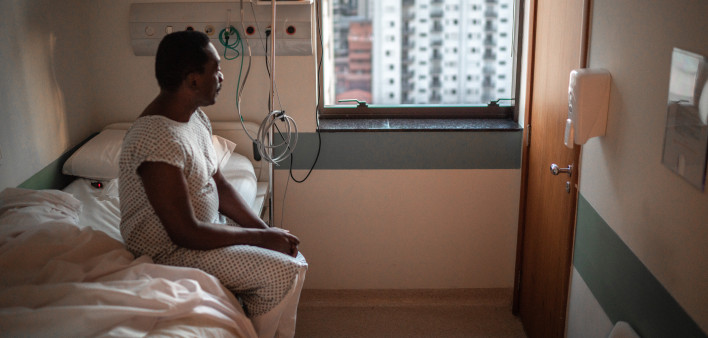 black patient in the hospital sitting in bed