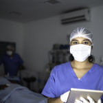 Portrait of female nurse using tablet at surgery on hospital