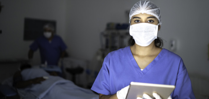 Portrait of female nurse using tablet at surgery on hospital