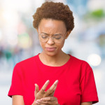 middle aged woman holding hands in pain