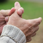 Elderly man has pain in fingers and hands. Old man with finger pain
