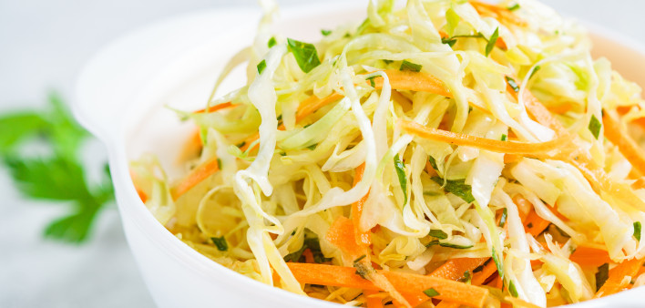 Fresh coleslaw salad in white bowl