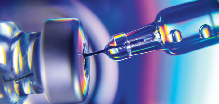 needle going into vial vaccine