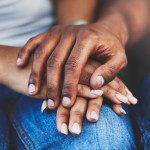 ethnic black latino man and woman holding hands