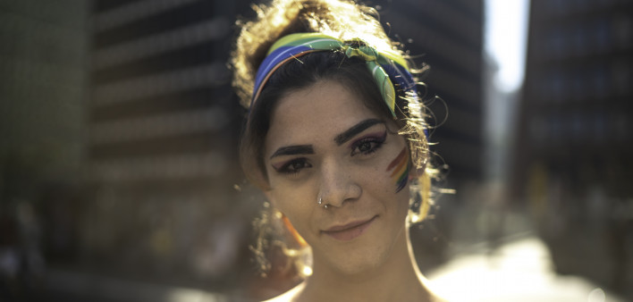 Transgender woman looking at camera during pride parade