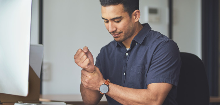 man holding wrist in pain