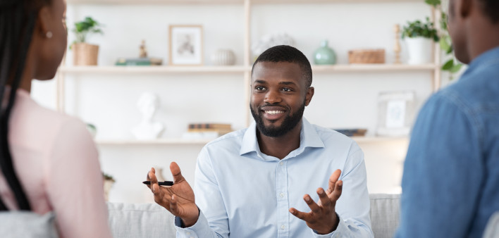 Family Psychotherapy. Friendly Black Therapist Consulting African American Couple At His Office