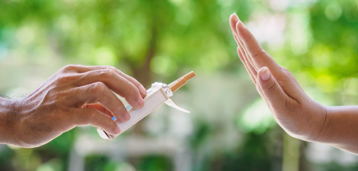 lose up of male hands holding cigarettes and proposing it to person.