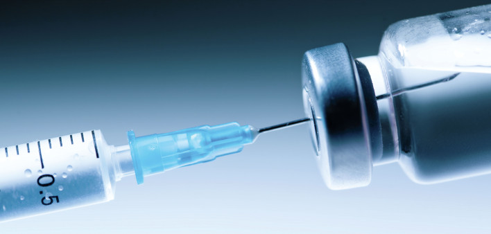 Medical syringe with a needle and a bollte with vaccine