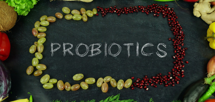 Probiotics on chalkboard with fruit