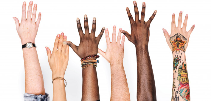 different race hands reaching upward