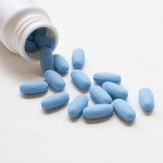 blue pills spilling out of bottle