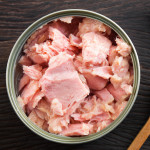 Canned soy free albacore white meat tuna packed in water on wood table background
