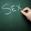 "SEX" being written on a blackboard