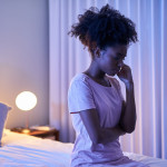 african woman in bedroom at night