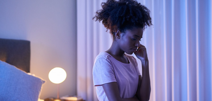 african woman in bedroom at night