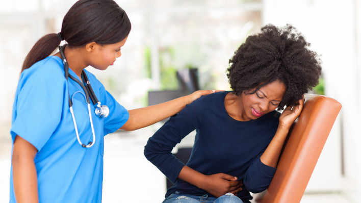 woman girl stomach cramps with nurse