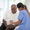 nurse helping patient fill out papers