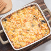 Baked macaroni casserole in a ceramic baking dish.