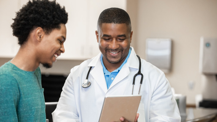 Doctor and patient looking at digital tablet in exam