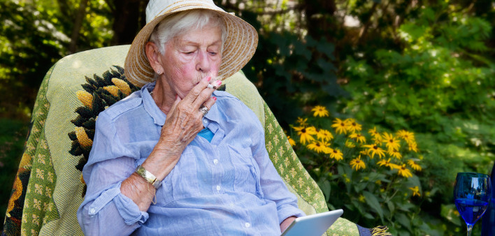 Happy senior woman smoking marijuana