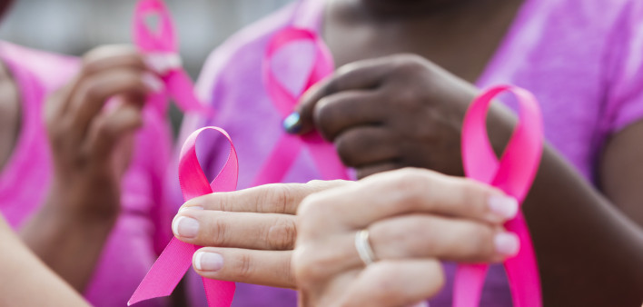 Multi-ethnic women with breast cancer awareness ribbons