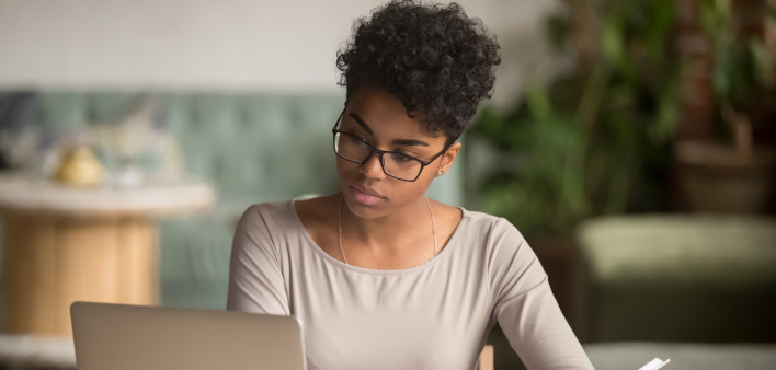 woman sitting at table with labtop