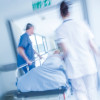 patient being wheeled on gurney in hospital