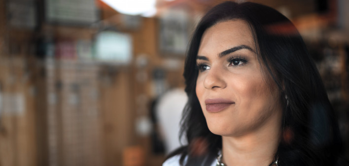 Transgender female looking through window