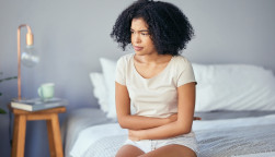 woman girl stomach cramps bed