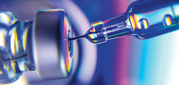 needle going into vial vaccine