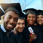Portrait of a group of students taking selfies on graduation day