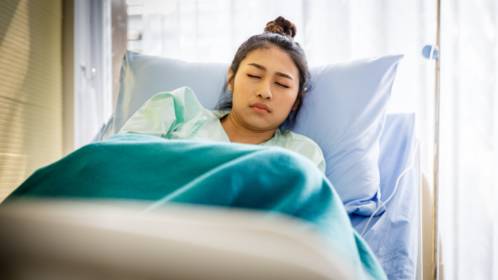 Patient with illness in hospital room
