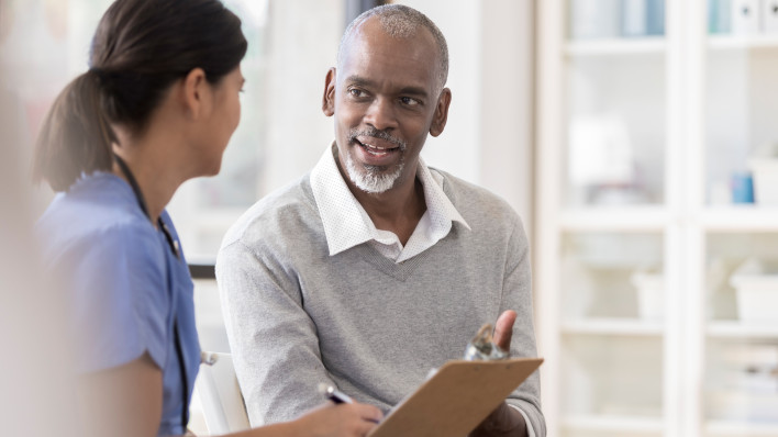 Senior man discusses diagnosis with doctor
