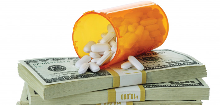 cost of healthcare bottle of pills on money