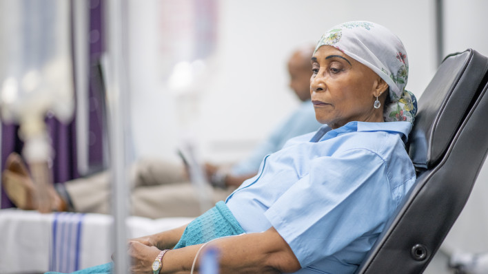 Senior adult woman in the oncology unit receiving chemotherapy treatment.