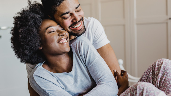 young happy couple smiling and embracing