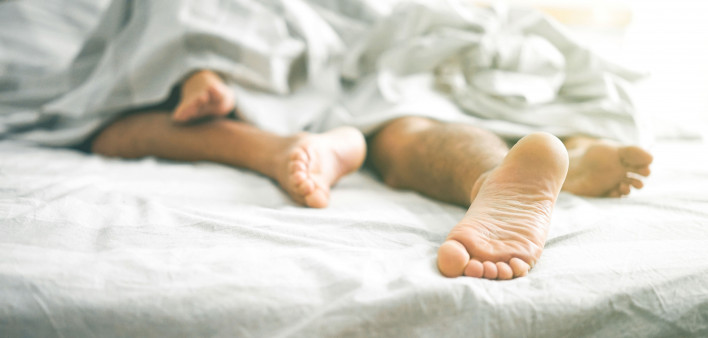 in bed sleeping feet showing