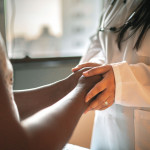 Doctor holding patients hands