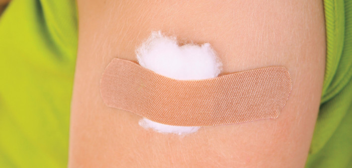 arm with band aid after vaccine