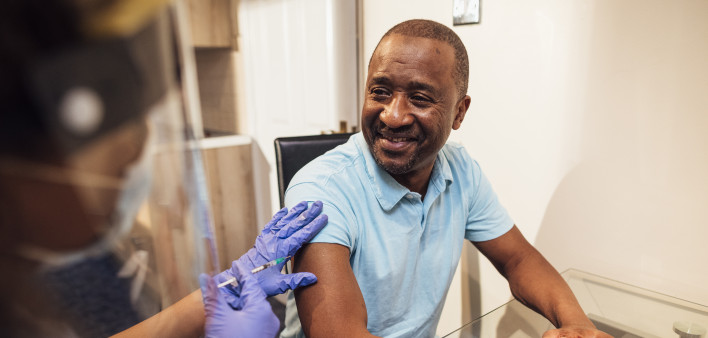 black man getting coronavirus vaccine