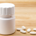 white pills and pill bottle medication generic image