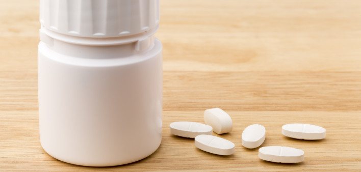 white pills and pill bottle medication generic image