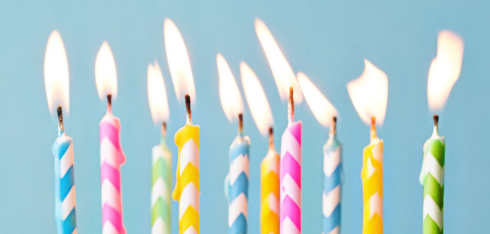 Birthday cake decorated with colorful sprinkles and ten candles