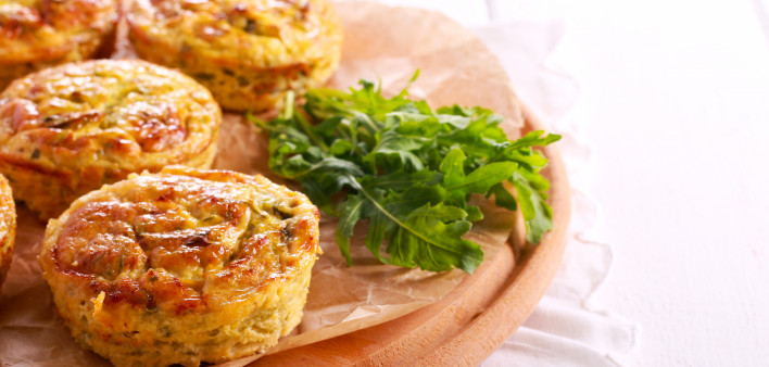 Courgette frittatas on wooden board on table