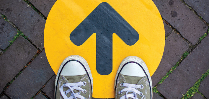 sneakers and yellow arrow sign