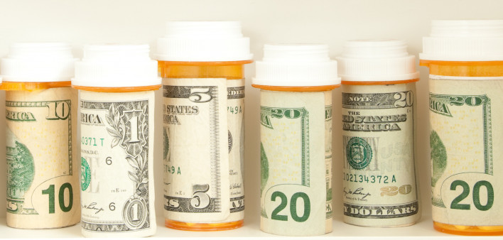 pill bottles with money as labels cost of healthcare