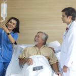 Doctor and patient healthcare concept. doctor and nurse, patient with iv drip in bed in hospital. Doctor and patient healthcare concept. doctor and nurse, patient with iv drip in bed in hospital. IV Drip Stock Photo Description  Doctor and patient healthc